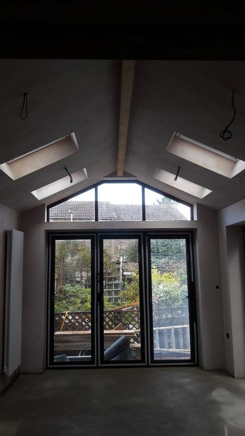 Interior of an extension with a vaulted ceiling, roof lights and gable glazing