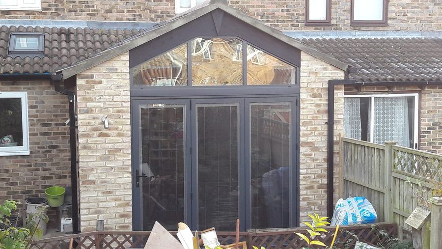 Rear extension with apex gable glazing above anthracite bifold doors